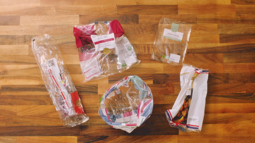 Salad bags and plastic film lid on a counter top